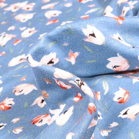 Tissu Jersey Viscose  Tess sur fond Bleu ciel