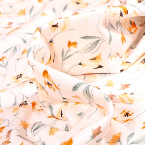 Tissu Jersey Viscose  Tess sur fond Blanc cassé