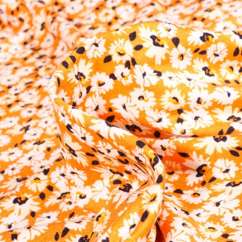 Tissu Jersey Viscose  Fleurs et pâquerettes sur fond Orange
