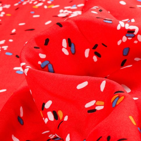Tissu Viscose Popeline Confettis multicolores sur fond Rouge