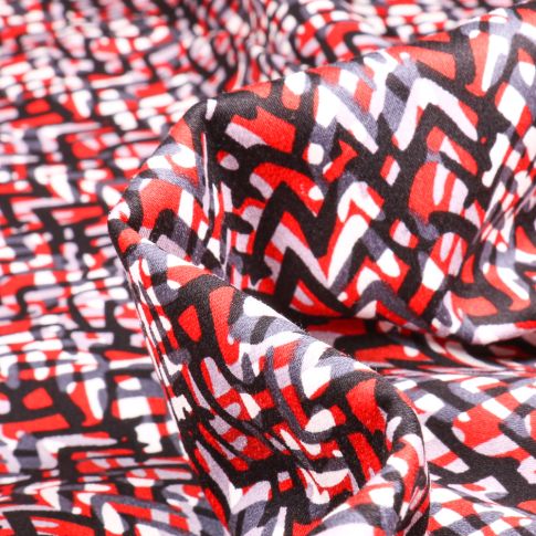 Tissu Coton satiné extensible Zig zag sur fond Rouge