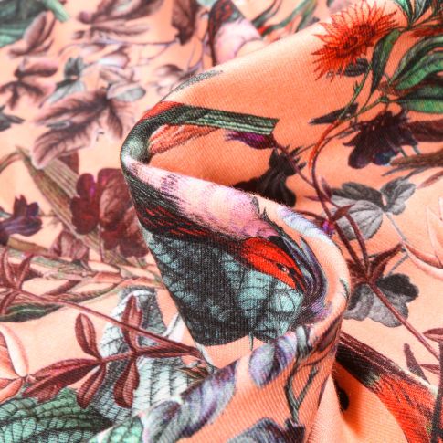 Tissu Jersey Coton Feuillages et oiseaux sur fond Saumon