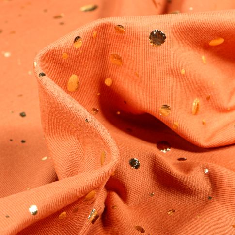 Tissu Jersey Coton Pois métallisés dorés sur fond Melon