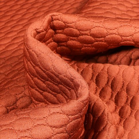 Tissu Sweat matelassé Alvéoles ovales sur fond Brique