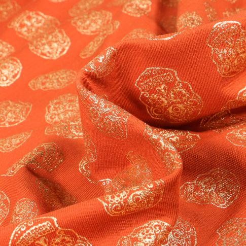 Tissu Jersey Coton Têtes de morts métallisées sur fond Orange