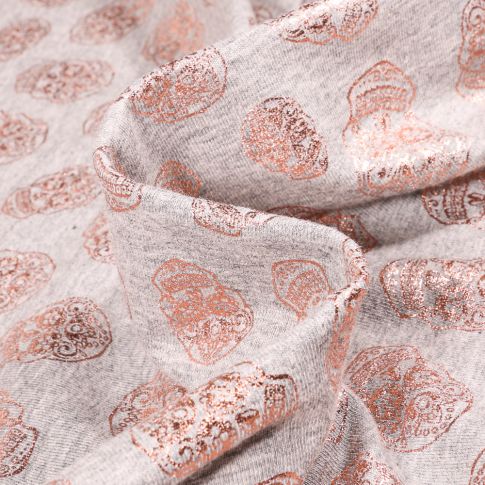Tissu Jersey Coton Têtes de morts métallisées sur fond Gris chiné