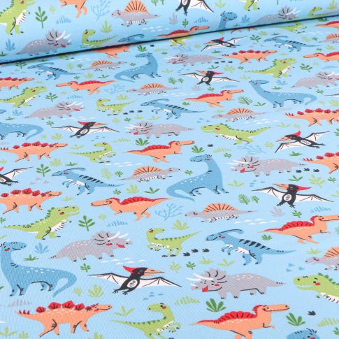 Tissu Jersey Coton Dinosaures multicolores sur fond Bleu ciel