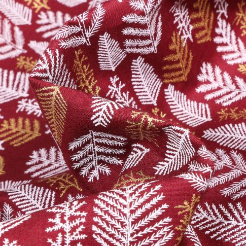 Tissu Coton imprimé Feuilles de sapins dorées et blanches sur fond Bordeaux