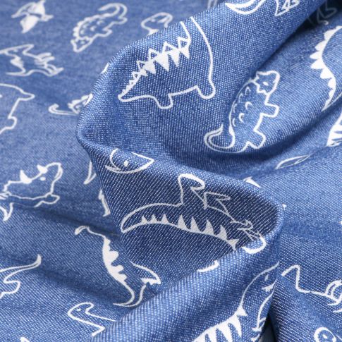 Tissu Jean Denim extensible Dinosaures sur fond Bleu denim