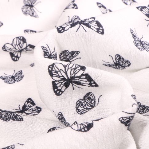 Tissu Viscose texturé Papillons bleu marine sur fond Blanc