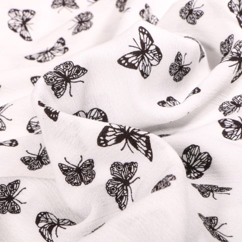 Tissu Viscose texturé Papillons noirs sur fond Blanc