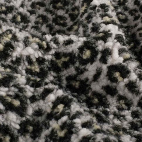 Tissu Fausse fourrure Mouton Yséa  léopard effet moucheté sur fond Blanc