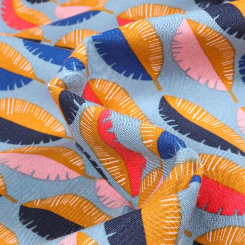 Tissu Viscose Arty Feuilles multicolores sur fond Bleu