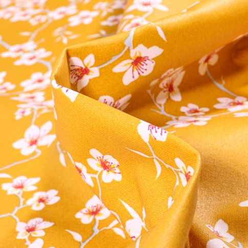 Tissu Coton enduit Fleur d'amandier sur fond Jaune safran