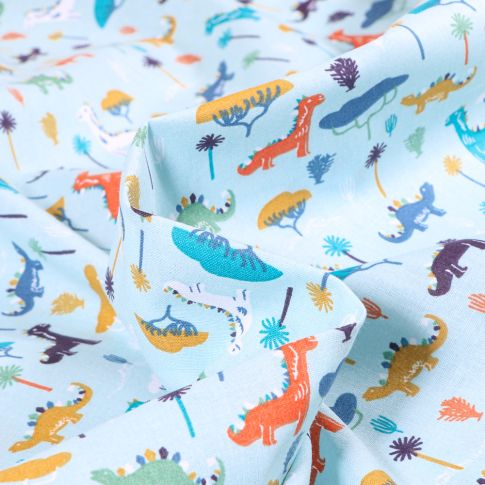 Tissu Coton imprimé Arty Dino colorés sur fond Bleu ciel
