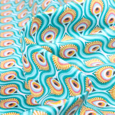 Tissu Coton enduit Feuilles de Paon sur fond Bleu lagon