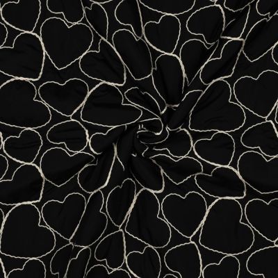 Tissu Matelassé Coeurs brodés Blanc sur fond Noir - Par 10 cm