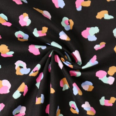 Tissu Jersey Bord Côte Mila motif léopard multicolore sur fond Noir profond - Par 10 cm