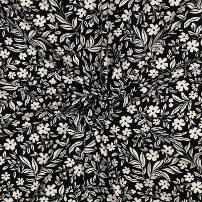 Tissu Jersey Coton imprimé Petites Fleurs Blanches sur fond Noir - Par 10 cm