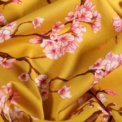 Tissu Viscose Lycra Branches et fleurs de cerisier sur fond Jaune curcuma - Par 10 cm