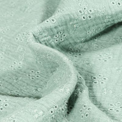 Tissu Double gaze brodé ajouré Petites fleurs sur fond Vert amande - Par 10 cm