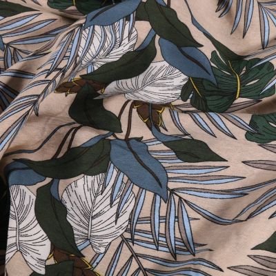Tissu Viscose  Feuilles bleues et vertes sur fond Beige - Par 10 cm
