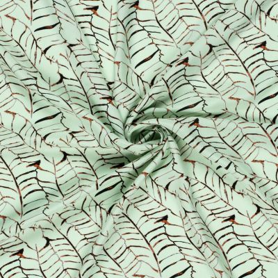 Tissu Popeline de Viscose imprimé Feuilles noires sur fond Vert menthe clair - Par 10 cm