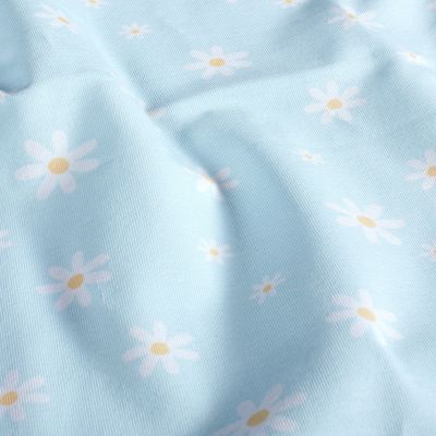 Tissu Jersey Coton Pâquerettes blanches et jaunes sur fond Bleu ciel - Par 10 cm