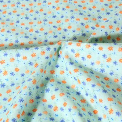 Tissu Popeline de Coton légère Petites fleurs sur fond Vert menthe - Par 10 cm
