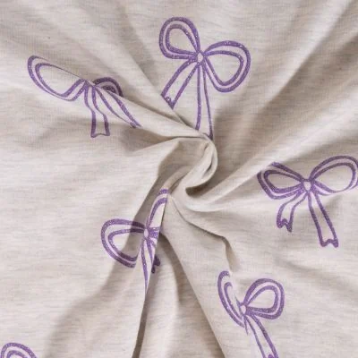 Tissu Jersey Mélangé Poppy Noeuds pailletés violets sur fond Ecru chiné - Par 10 cm