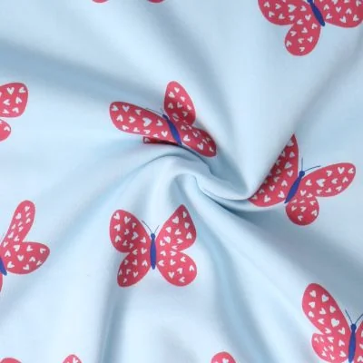Tissu Sweat envers molletonné Lili papillons Rouges sur fond Bleu ciel - Par 10 cm