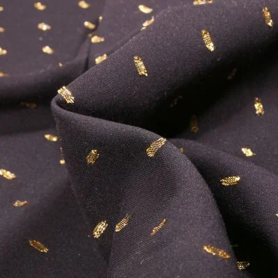 Tissu Viscose Confettis dorés sur fond Noir - Par 10 cm
