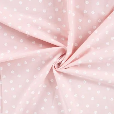 Tissu Popeline de Coton  patounes blanches Zumi sur fond Rose clair - Par 10 cm
