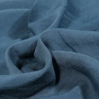 Tissu Viscose Lin Uni Lino sur fond Bleu denim - Par 10 cm