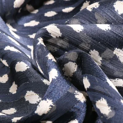 Tissu Mousseline Dots Lurex écru sur fond Bleu marine - Par 10 cm